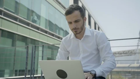Medium shot of young Caucasian manager working on laptop Stock Footage 97921066