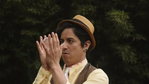 Medium shot of a young circus performer who is mastering a juggling trick using Stock Footage 113938132