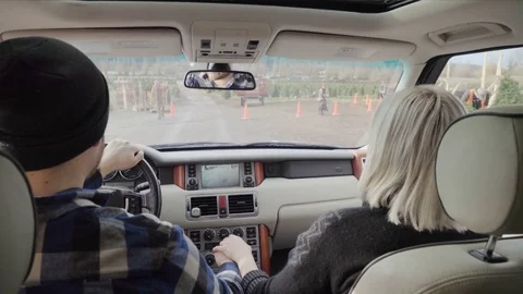 Medium shot of a young couple arriving at a tree farm by car 動画素材 73068914