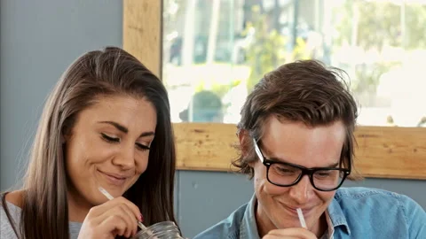 Medium shot of young couple using digital tablet computer in cafe. Stock Footage 199634740