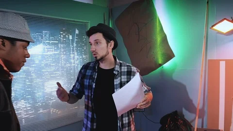 Medium shot of Young director teaching understudies during scene shooting Stock Footage 124332219