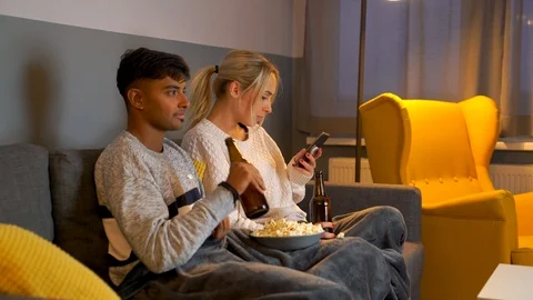 Medium shot of young girl checking her phone while watching TV. Stock Footage 119303133