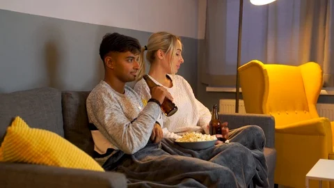 Medium shot of young girl checking her phone while watching TV. Stock Footage 119303177