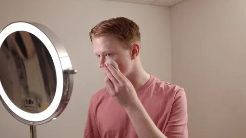 A Medium Shot Of A Young Man Applying Foundation Skincare Makeup Routine Stock Footage 309350725