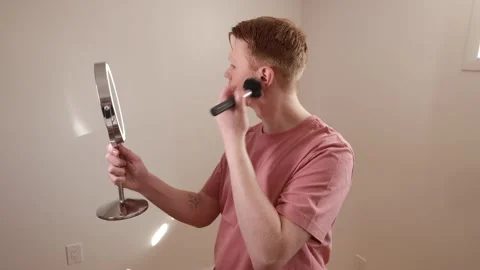 A Medium Shot of A Young Man Applying Eyeshadow in Front of Mirror Stock Footage 309892798