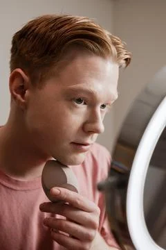 A Medium Shot Of A Young Man Applying Foundation Skincare Makeup Routine Stock Photos