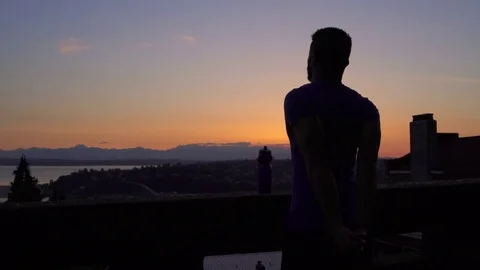 Medium shot of young man stretching in twilight 動画素材 76236697