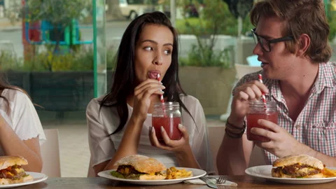 Medium shot of young multicultural group of friends laughing/ enjoying and shari Stock Footage 199634809