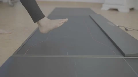 Medium shot young people step on dynamic pad foot pressure equipment 4k Stock Footage 218887865