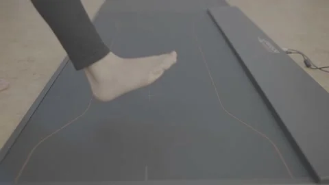 Medium shot young people step on dynamic pad foot pressure equipment 4k Stock Footage 218887867