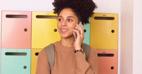 Medium shot young student texting, answer phone and talking, smiling on campus Stock Footage 244538239