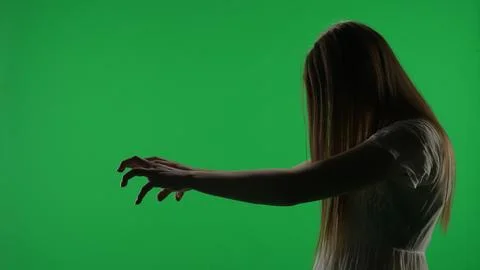 Medium side view green screen, chroma key shot of a posessed female figure Foto stock