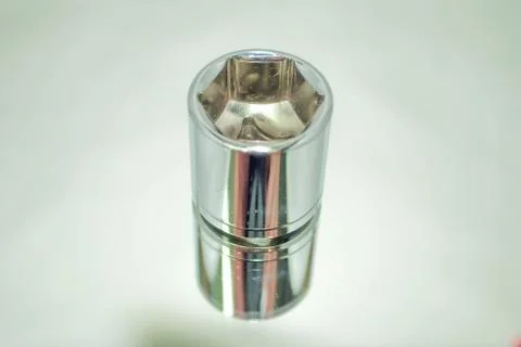 Medium size chrome ratchet socket on mirror close-up Foto stock