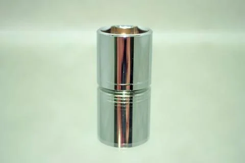 Medium size chrome ratchet socket on mirror close-up Stock Photos