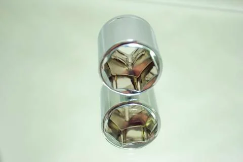 Medium size chrome ratchet socket on mirror close-up Stock Photos
