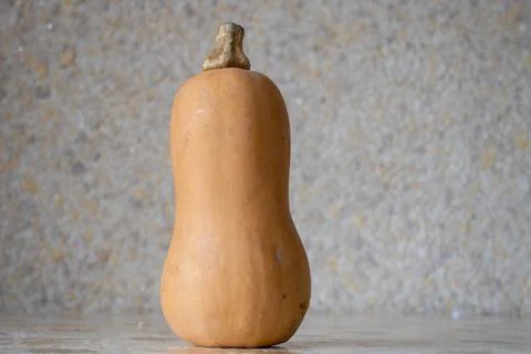 A medium sized carving pumpkin on display at a farmers market. Vertical forma Stock Photos