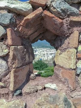 Medium-sized city seen through the window of the old castle Foto stock