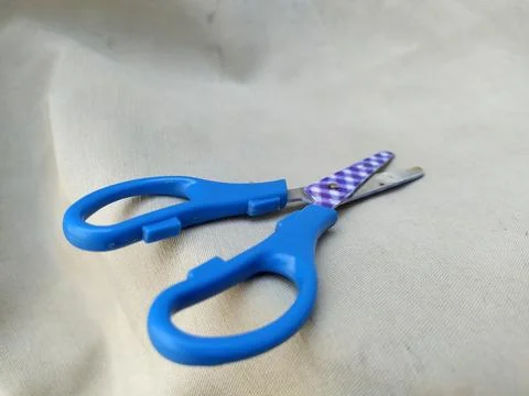 Medium sized paper scissors with light blue handles Stock Photos