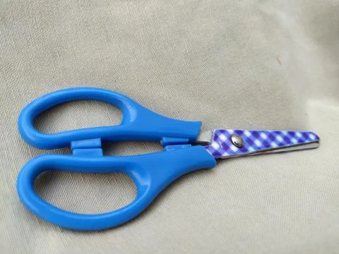 Medium sized paper scissors with light blue handles Stock Photos