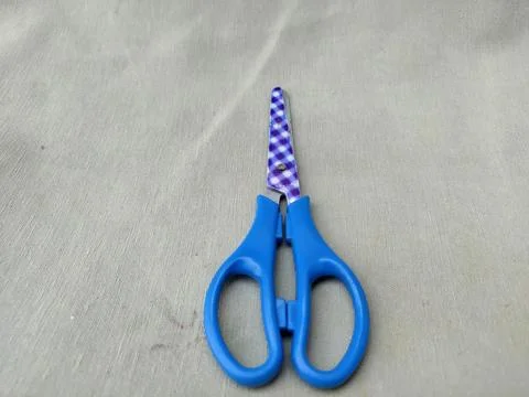 Medium sized paper scissors with light blue handles Stock Photos
