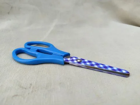 Medium sized paper scissors with light blue handles Stock Photos