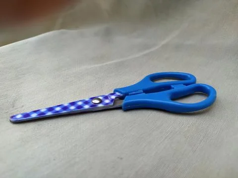 Medium sized paper scissors with light blue handles Stock Photos
