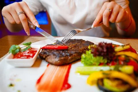 Medium-sized steak with vegetables in a cafe. Stock Photos