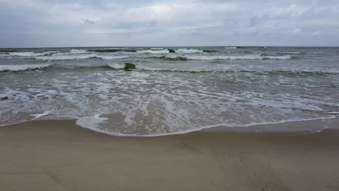Medium sized waves crushing on sandy beach Stock Footage 251190843