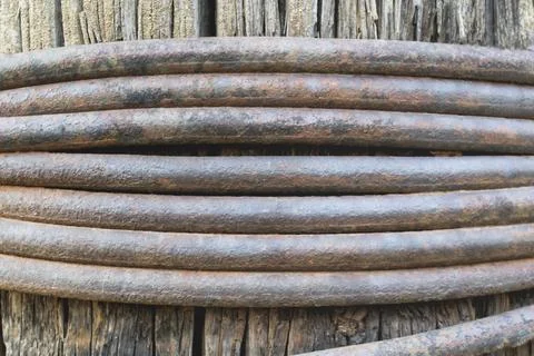 Medium sized wire wrapped around a wooden core as a background Stock Photos