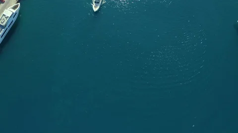 Medium sized Yacht roaring across The Mediterranean Sea - Top down aerial Stock Footage 119324729