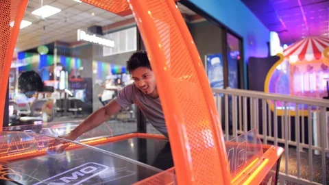 Medium Sliding shot of someone playing air hockey with a nice parallax from the Stock Footage 92456333