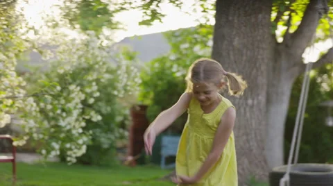 Medium slow motion panning shot of girl dancing in yard / Springville, Utah, Stock Footage 68217497