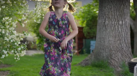 Medium slow motion panning shot of girl dancing in yard / Springville, Utah Stock Footage 68845699