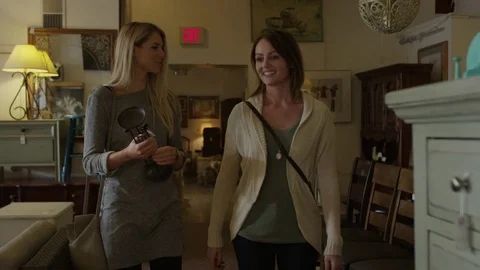 Medium slow motion tracking shot of women browsing in antique store / Salt Lake Stock Footage 77477143