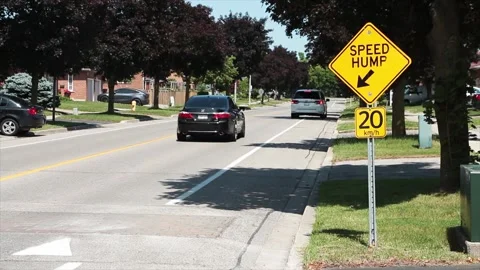 Medium on speed hump arrow 20 km/h sign in black writing on yellow background Stock Footage 246134008