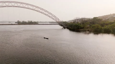 Medium spin around small boat in Volta River 動画素材 299750914