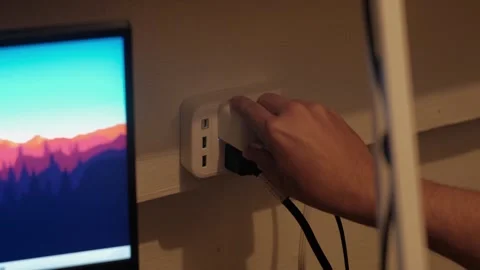 Medium Static Shot of Plugging Charger into Wall Outlet Video stock 335436670