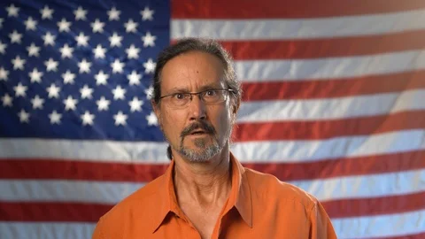Medium tight portrait of mature man with beard wearing an orange shirt and Stock Footage 126779080