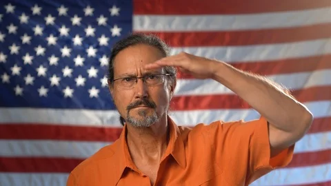 Medium tight portrait of mature man with beard wearing an orange shirt and Video stock 126779375