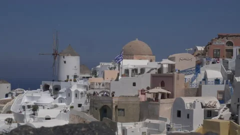 Medium of tourists walking among the windmills in Oia on Santorini Vídeos de archivo 239486566