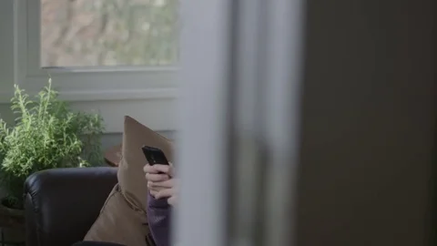 Medium tracking shot of a lady using her cell phone Stock Footage 70809620