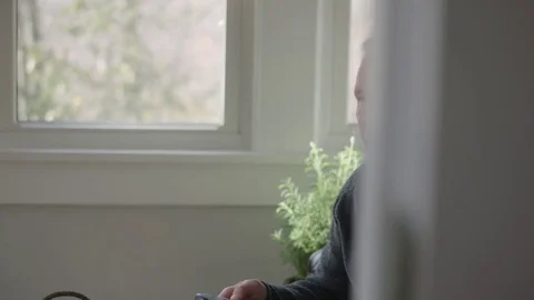 Medium tracking shot of an older man watching sports and celebrating a score Stock Footage 70809860