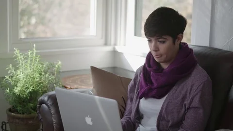 Medium tracking shot of young lady getting frustrated with slow wifi Stock Footage 70809413