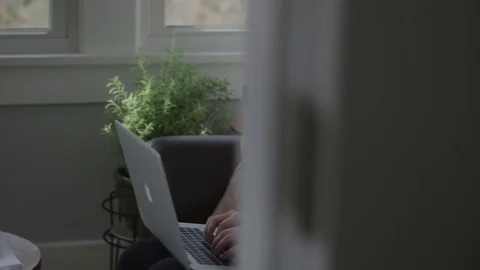 Medium tracking shot of a young lady using a laptop Stock Footage 71326673