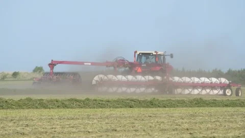 Medium Tracking of a Tractor and Rake Stock Footage 221868819