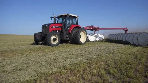 Medium Tracking of a Tractor and Rake - Slide Back Stock Footage 229325151