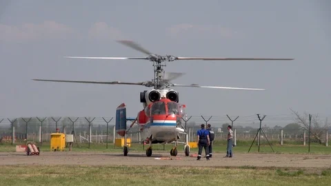 Medium transport helicopter Ka-32 on helipad with running engines. Stock Footage 118647474