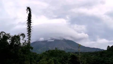 MEDIUM VIEW AN ACTIVE VOLCANO MOUNTAIN WITH BLUE SKY IN THE MORNING Video stock 203095914