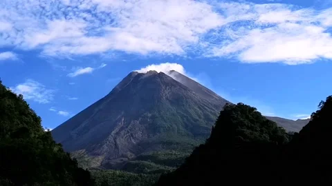 MEDIUM VIEW AN ACTIVE VOLCANO MOUNTAIN WITH BLUE SKY IN THE MORNING Video stock 203096315