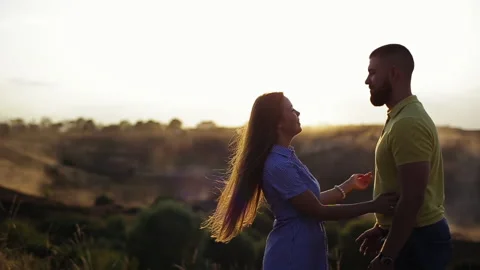 Medium view of young couple in love with bearded guy and beautiful girl hugging Stock Footage 141969437